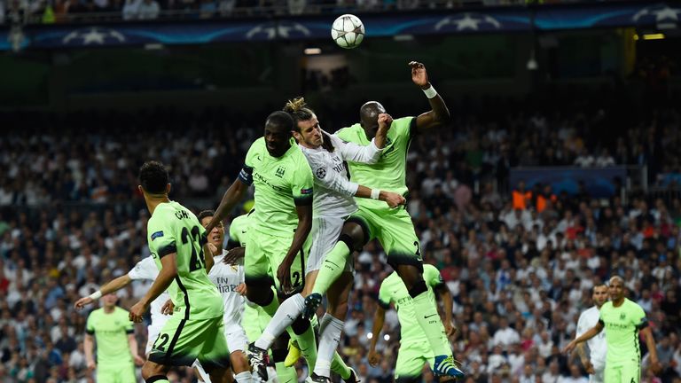 MADRID, SPAIN - MAY 04:  Gareth Bale of Real Madrid competes for a header with Yaya Toure and Eliaquim Mangala of Manchester City during the UEFA Champions