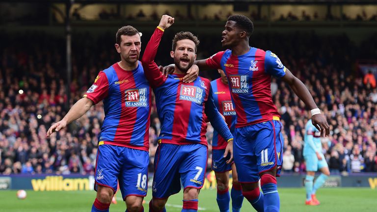 Yohan Cabaye (C) of Crystal Palace celebrates scoring his team's first goal with his team mates James McArthur (L) and Wilfried Zaha