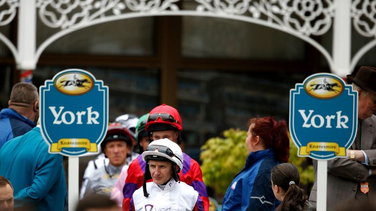 Jockeys make their way into the parade ring before the first race at York on Yorkshire Cup day.