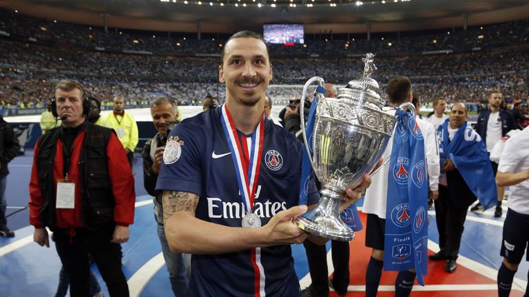 Paris-Saint-Germains Swedish forward Zlatan Ibrahimovic holds up the trophy after winning the French Cup final football match against Auxerre at the Stade 