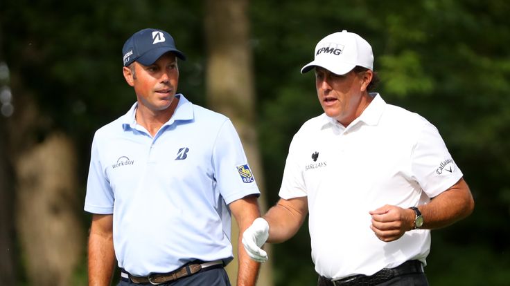 Matt Kuchar talks with Phil Mickelson as they walk down the fairway on the 13th hole during the second round of The Memorial Tournament