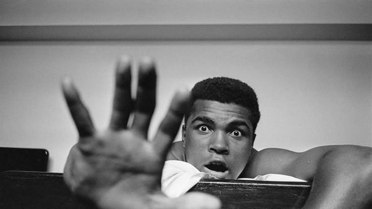 Muhammad Ali lying on a hotel bed in London, 1963