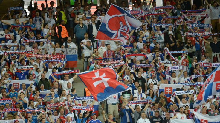 Slovakia supporters wave flags and scarves during the Euro 2016 group B football match between Russia and Slovakia at the Pierre-Mauroy Stadium in Villeneu