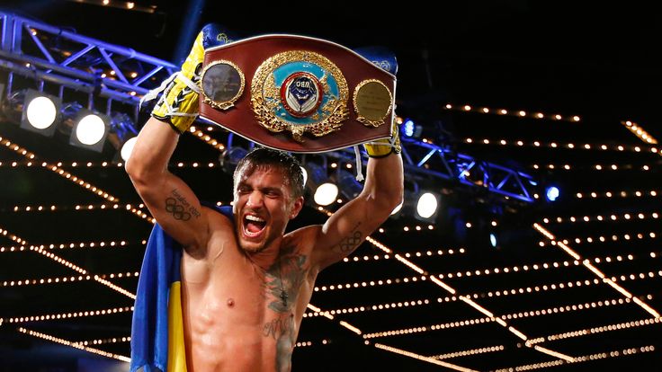 Vasyl Lomachenko holds the championship belt after defeating Roman Martinez by knock out during the fifth round of their Junior Lig