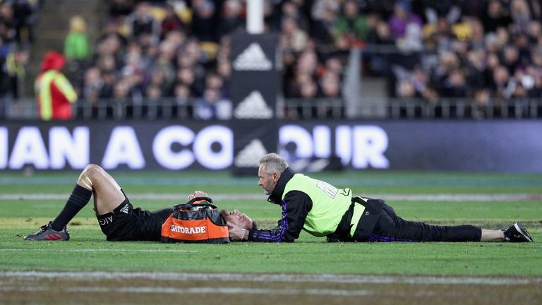 Aaron Cruden receives treatment after suffering a neck injury during the second Test between New Zealand and Wales