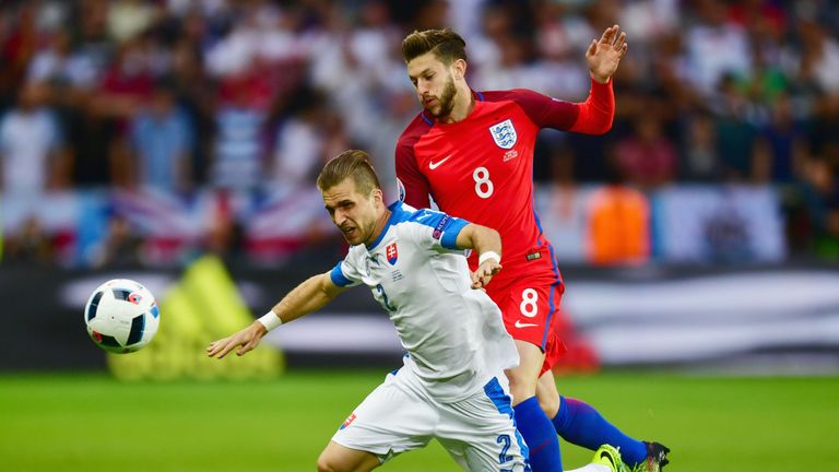 Peter Pekarik of Slovakia is challenged by Adam Lallana of England