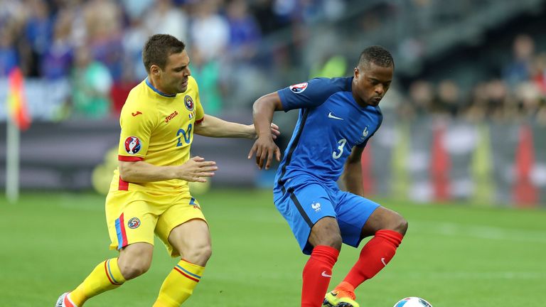 Adrian Popa keeps track of Patrice Evra