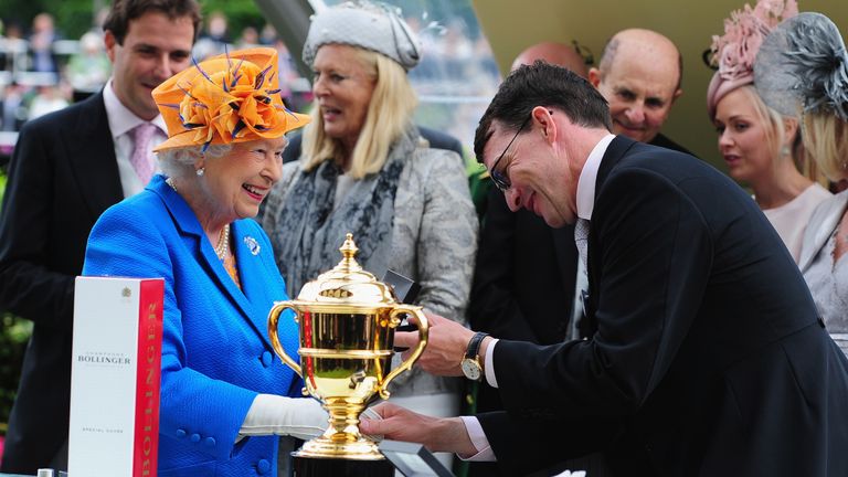 Queen Elizabeth II chats to Trainer Aidan O'Brien after training Order of St George to victory in the Gold Cup