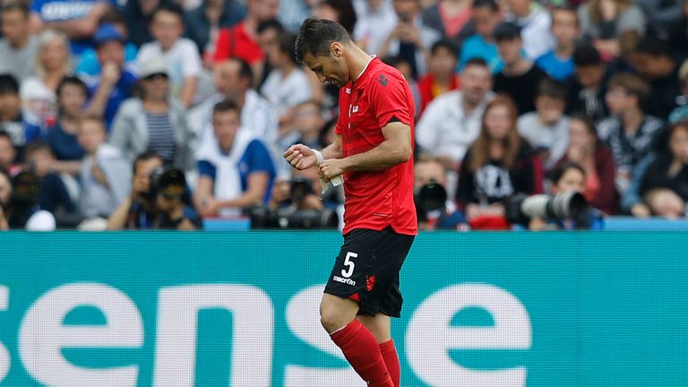 Albania's Lorik Cana walks off the pitch after getting a red card 