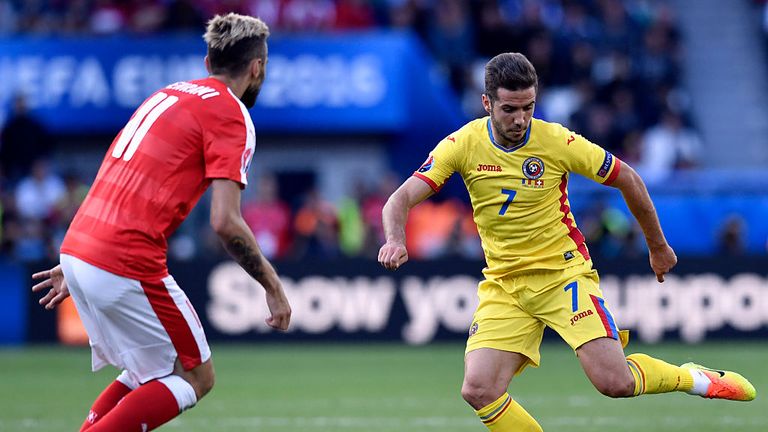 Romania's midfielder Alexandru Chipciu (R) vies for the ball 