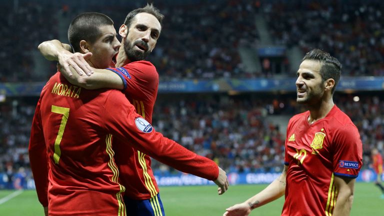 Spain's Alvaro Morata, left, celebrates with his teammates Juanfran and Cesc Fabregas, right, after scoring his side's 