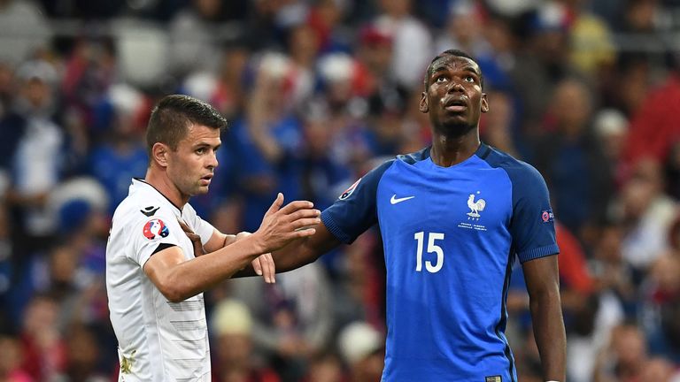 Albania midfielder Amir Abrashi (L) gestures as France midfielder Paul Pogba holds him back during the Euro 2016 group A football match in Marseille