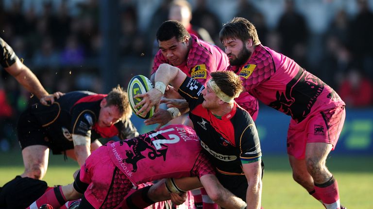 NEWPORT, WALES - FEBRUARY 08:  Andrew Coombs of the Dragons looks for an offload as he is tackled by Seb Jewell of London Welsh during the LV= Cup match be
