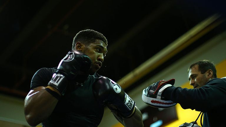 Joshua works out on the pads with Tony Sims