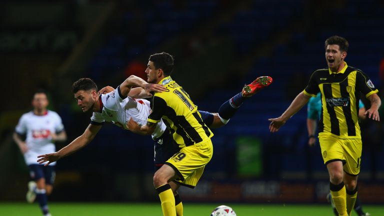 BOLTON, ENGLAND - AUGUST 11:  Gary Madine of Bolton Wanderers tangles with Anthony O'Connor of Burton Albion during the Capital One Cup first round match b
