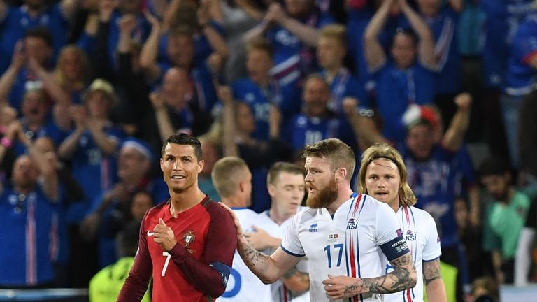  Iceland's midfielder Aron Gunnarsson (R) taps Portugal's forward Cristiano Ronaldo (L) on the shoulder at the end of the Euro 2016 group F football match 