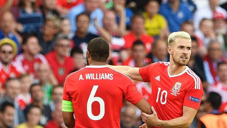 Wales' defender Ashley Williams (L) and Wales' midfielder Aaron Ramsey speak to the manager on Saturday