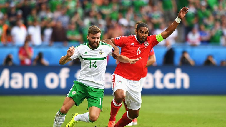 PARIS, FRANCE - JUNE 25:  Stuart Dallas of Northern Ireland and Ashley Williams of Wales compete for the ball during the UEFA EURO 2016 round of 16 match