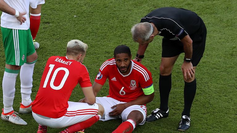 Referee Martin Atkinson (right) with Wales' Ashley Williams after picking up a injury during the round of 16 match at the Parc de Princes, Paris.