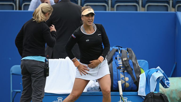 BIRMINGHAM, ENGLAND - JUNE 15: Belinda Bencic of Switzerland receives treatment from the trainer during her women's singles first round match Irina-Camelia