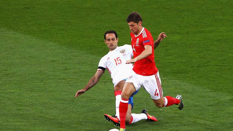 Ben Davies of Wales is tackled by Roman Shirokov of Russia