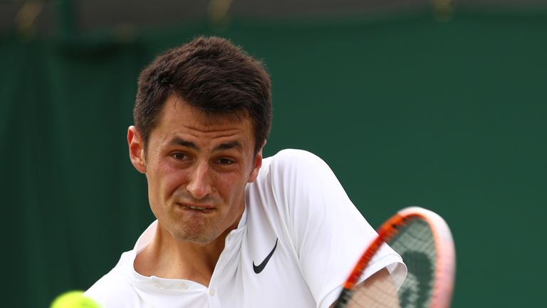 LONDON, ENGLAND - JUNE 30:  Bernard Tomic of Australia plays a backhand during the Men's Singles second round match against Radu Albot of Moldova on day fo