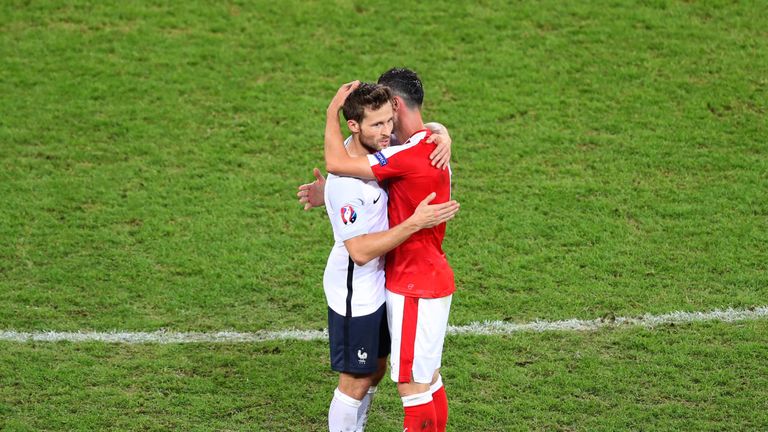 Switzerland's Blerim Dzemaili and France's Yohan Cabaye hug each other at full time