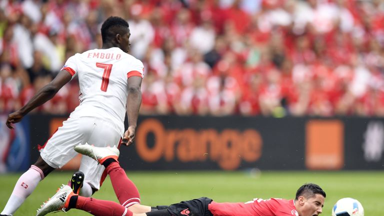 Albania's midfielder Odise Roshi (bottom) is challenged by Switzerland's forward Breel Embolo during the Euro 2016 group A football match between Albania a