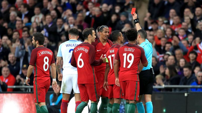 Portugal's Bruno Alves (centre) is shown the red card by referee Marco Guida (right) for a dangerous challenge on England's Harry Kane