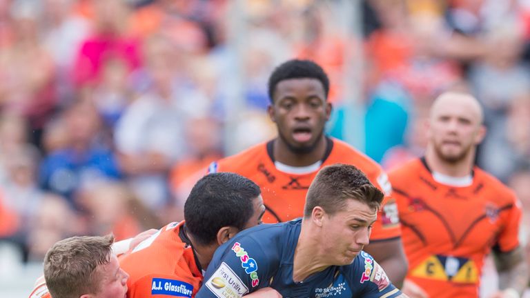Hull FC's Jamie Shaul is tackled by Castleford's Adam Milner and Junior Moors