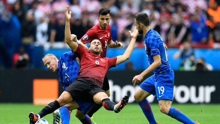 PARIS, FRANCE - JUNE 12:  Cenk Tosun of Turkey is challenged by Domagoj Vida of Croatia during the UEFA EURO 2016 Group D match between Turkey and Croatia 