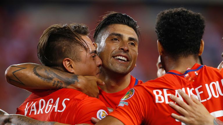 Eduardo Vargas #11 of Chile is congratulated by teammates Gonzalo Jara #18 and Jean Beausejour #15 after scoring second goal of