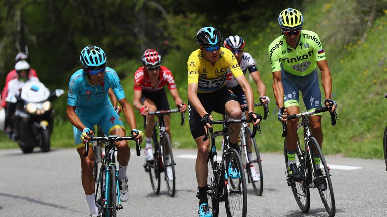 Race leader Chris Froome of Great Britain and Team SKY rides alongside Alberto Contador of Spain and the Tinkoff team duri
