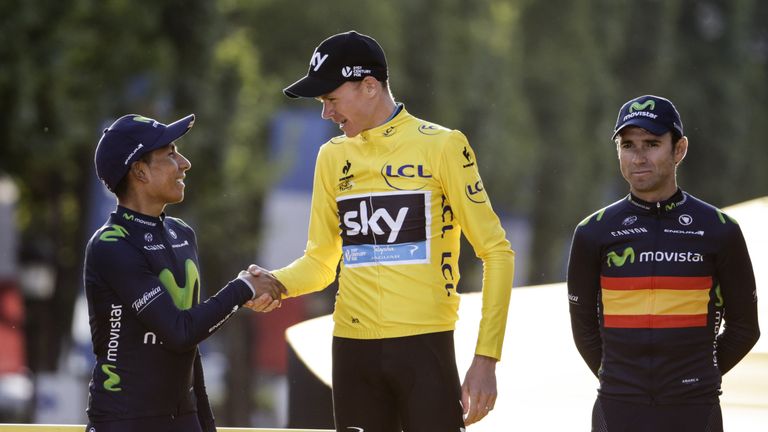 Tour de France 2015's winner Great Britain's Christopher Froome (C) shakes hand with second-placed Colombia's Nairo Quintana (L), as third-placed Spain's A