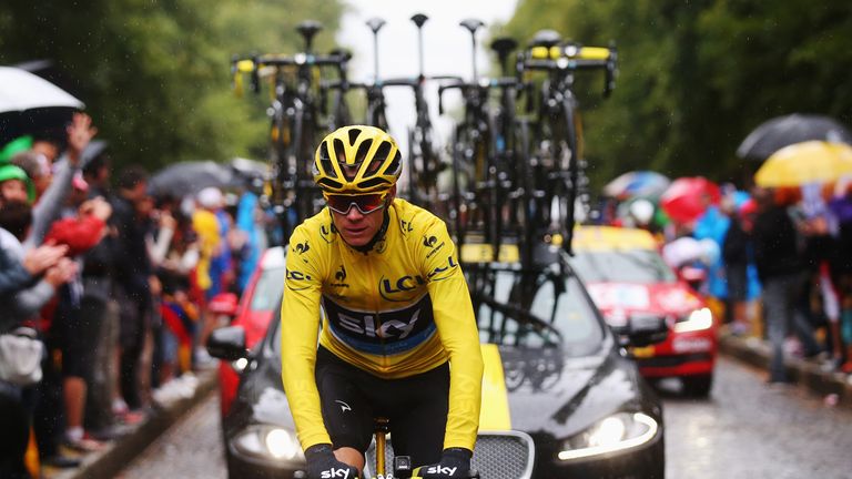 PARIS, FRANCE - JULY 26:  Team Sky cyclist Chris Froome celebrates winning the 2015 Tour de France alongside the Jaguar Sportbrake support car on July 26, 