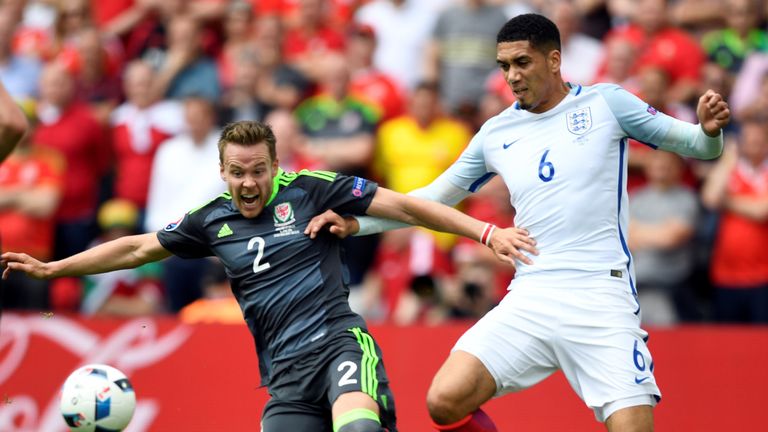 Wales' defender Chris Gunter (L) vies for the ball with England's defender Chris Smalling  during the Euro 2016 group B football match between England and 