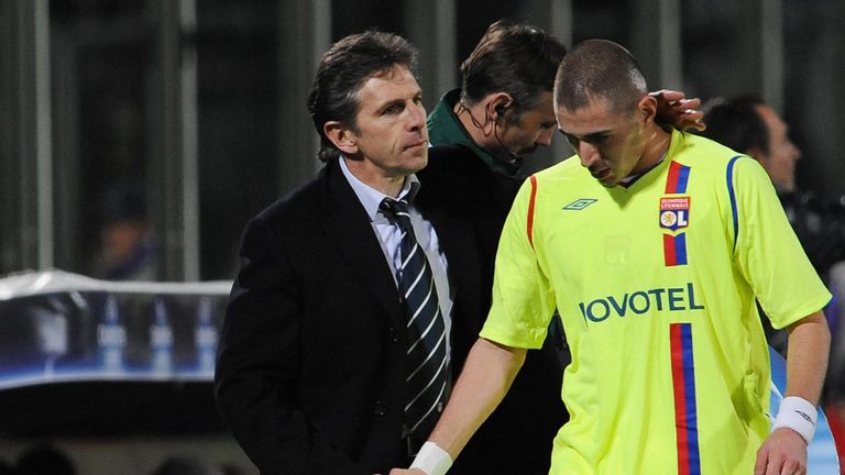 Lyon's coach Claude Puel ( L) congratulates forward Karim Benzema