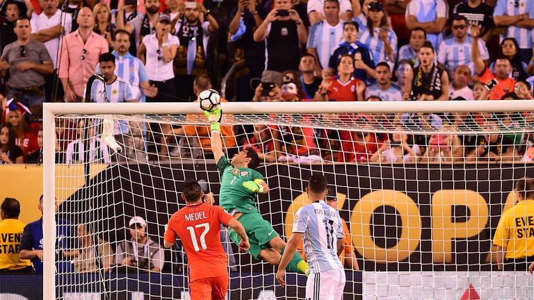 Chile's goalkeeper Claudio Bravo pulls off a save following a header by Argentina's Sergio Aguero