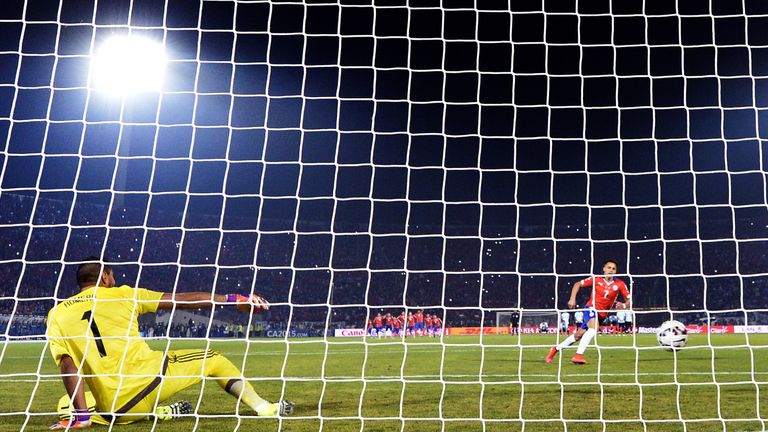 Chile's forward Alexis Sanchez scores against Argentina during the penalty shootout of the 2015 Copa America football championship final, in Santiago