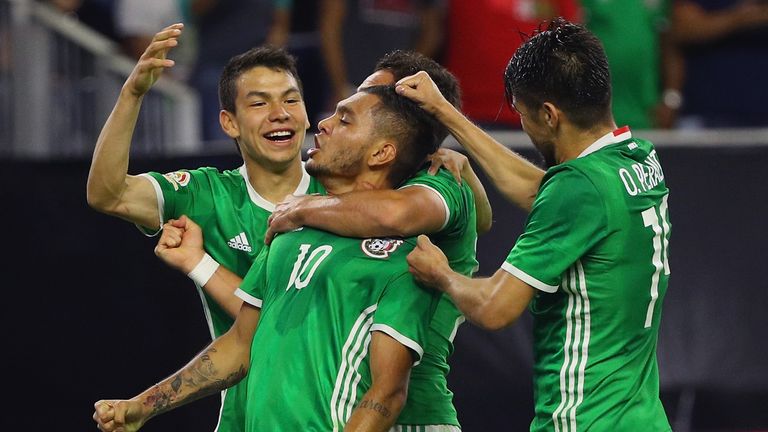 Corona is mobbed by team-mates after scoring the goal which ensured Mexico topped their group