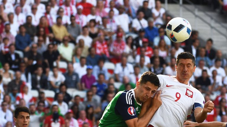 Northern Ireland's defender Craig Cathcart (L) vies with Poland's forward Robert Lewandowski during the Euro 2016 group C football match between Poland and