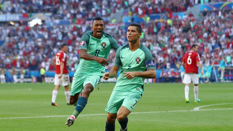 Cristiano Ronaldo (R) of Portugal  celebrates scoring his team's second goal with his team mate Nani (L)