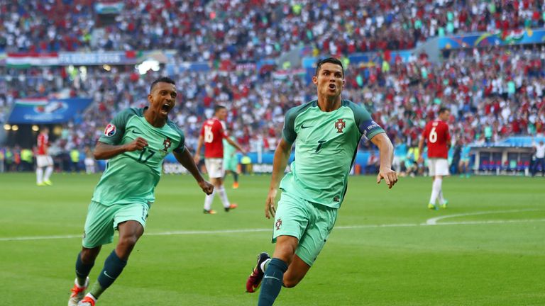 Cristiano Ronaldo (R) of Portugal  celebrates scoring his team's second goal against Hungary with his team-mate Nani (L)