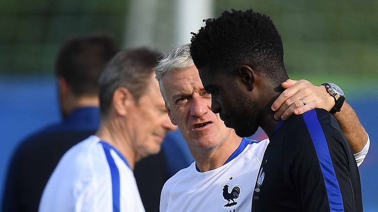 France's head coach Didier Deschamps (L) speaks with France's defender Samuel Umtiti 