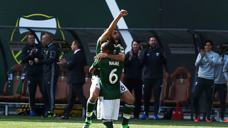 PORTLAND, OR - APRIL 6: Darlington Nagbe #6 of Portland Timbers lifts Diego Valeri #8 of Portland Timbers into the air after Valeri scored a goal during th