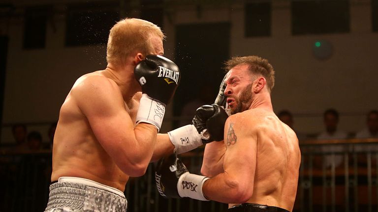 Enzo Maccarinelli (R) takes a left hook from Dmytro Kucher