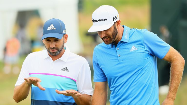 Dustin Johnson of the United States talks to Sergio Garcia of Spain