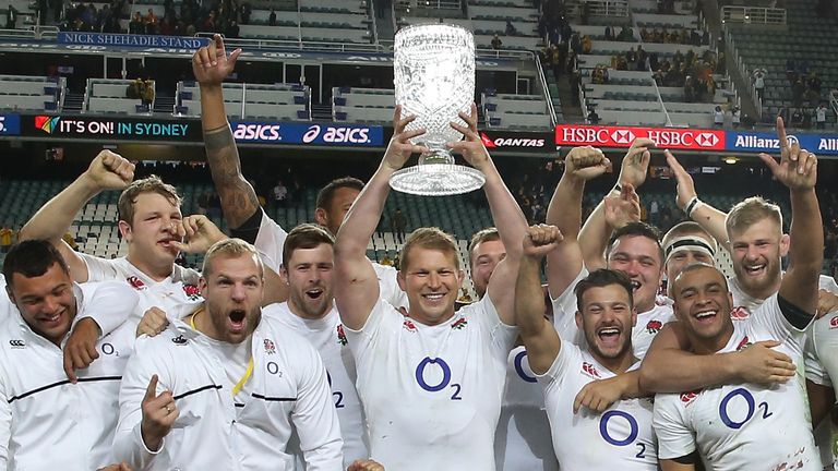 Dylan Hartley, the England captain, lifts the Cook Cup and celebrates with team mates 