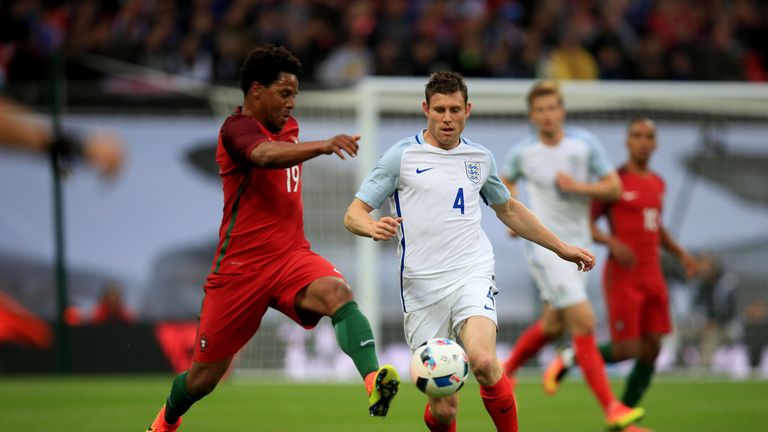 Portugal's Eliseu and England's James Milner (right) battle for the ball 