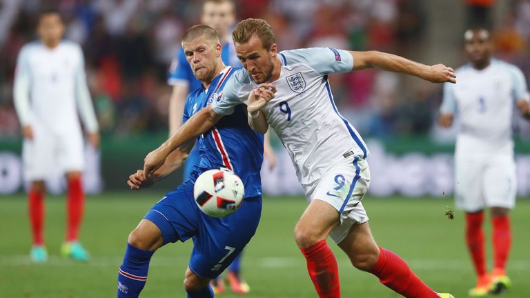 Harry Kane of England and Johann Gudmundsson of Iceland compete for the ball during the UEFA EURO 2016 round of 16 match between En